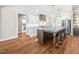Modern kitchen with large island and hardwood floors at 145 Wiggins Rd, Louisburg, NC 27549