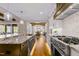 Bright kitchen with stainless steel appliances, granite countertops, and an open floor plan at 145 Wiggins Rd, Louisburg, NC 27549