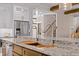 Island kitchen features double sinks, granite countertops and a modern design at 145 Wiggins Rd, Louisburg, NC 27549