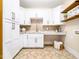Bright laundry room with white cabinets, granite countertops, and storage at 145 Wiggins Rd, Louisburg, NC 27549