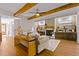 Spacious living area with a stone fireplace, hardwood floors and exposed beams at 145 Wiggins Rd, Louisburg, NC 27549