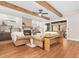 Living room boasts a cozy fireplace, hardwood floors and exposed wooden beams at 145 Wiggins Rd, Louisburg, NC 27549
