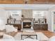 Living room with stone fireplace, built-in shelving and hardwood floors at 145 Wiggins Rd, Louisburg, NC 27549