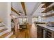 Open living area with hardwood floors, exposed beams and a view into the kitchen at 145 Wiggins Rd, Louisburg, NC 27549