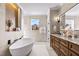 Luxurious bathroom with soaking tub and double vanity at 145 Wiggins Rd, Louisburg, NC 27549