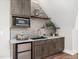 Stylish wet bar with microwave, mini-fridge and granite countertop at 145 Wiggins Rd, Louisburg, NC 27549