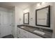 Modern bathroom featuring double sinks, grey countertops, framed mirrors, and updated fixtures at 1817 Hinesley Dr, Durham, NC 27703