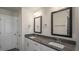 A modern bathroom featuring double sinks, mirrors, and modern fixtures, designed for convenience and style at 1825 Hinesley Dr, Durham, NC 27703