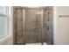 This bathroom features a modern glass shower with gray tile and an undermount shower seat at 1825 Hinesley Dr, Durham, NC 27703