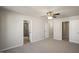 Bright bedroom with doorways to bathroom and closet spaces with neutral walls and carpet at 1825 Hinesley Dr, Durham, NC 27703