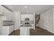 Open kitchen with stainless steel appliances, white cabinets, center island, and beautiful wood flooring at 1825 Hinesley Dr, Durham, NC 27703