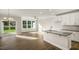 Kitchen and Living Room featuring hardwood floors, modern kitchen appliances, and large windows overlooking the backyard at 1825 Hinesley Dr, Durham, NC 27703
