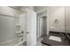 Bathroom featuring a tiled shower and tub, vanity with storage and light grey countertop, and chrome hardware at 1829 Hinesley Dr, Durham, NC 27703
