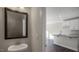 Elegant half bath with a modern sink, mirror and fixtures adjacent to an open kitchen layout at 1829 Hinesley Dr, Durham, NC 27703