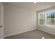 Bright bedroom features neutral walls, carpet flooring, a ceiling light and windows with natural light at 1829 Hinesley Dr, Durham, NC 27703