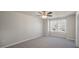 Spacious carpeted bedroom featuring neutral walls, a ceiling fan and a large window with exterior views at 1829 Hinesley Dr, Durham, NC 27703