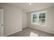 Bright bedroom features neutral walls, carpet flooring, a ceiling light and windows with natural light at 1829 Hinesley Dr, Durham, NC 27703