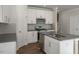 Modern kitchen equipped with stainless steel appliances, gray countertops, and white cabinetry at 1829 Hinesley Dr, Durham, NC 27703