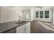 Modern kitchen island featuring a sink, gray countertops, and white cabinets at 1829 Hinesley Dr, Durham, NC 27703