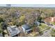 This two-story home with blue siding is surrounded by mature trees, with other homes nearby at 417 Elm St, Raleigh, NC 27604