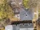 This two-story home with a stone patio is overlooked by mature trees and adjacent buildings at 417 Elm St, Raleigh, NC 27604