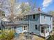 Two-story home featuring a stone patio, table and chairs, and blue siding, ideal for outdoor entertaining at 417 Elm St, Raleigh, NC 27604
