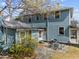 Two-story home featuring a stone patio, table and chairs, and blue siding, ideal for outdoor entertaining at 417 Elm St, Raleigh, NC 27604