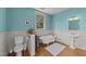 Bright bathroom features wainscoting, hardwood floors, a tub, and natural light at 417 Elm St, Raleigh, NC 27604