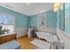 Bright bathroom with a clawfoot tub, a pedestal sink, and wainscoting at 417 Elm St, Raleigh, NC 27604