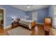 Cozy bedroom with hardwood floors, two windows, and soft natural light at 417 Elm St, Raleigh, NC 27604