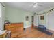 Light-filled bedroom features wood floors, a ceiling fan, a dresser, and natural light at 417 Elm St, Raleigh, NC 27604