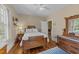 A bedroom with hardwood floors, vintage furniture, and an abundance of natural light at 417 Elm St, Raleigh, NC 27604