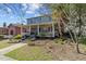 Two-story blue house with a wide front porch, garden and mature trees at 417 Elm St, Raleigh, NC 27604