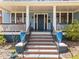 Inviting front porch with decorative columns and colorful planters leading up to the main entrance at 417 Elm St, Raleigh, NC 27604