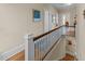 A hallway with hardwood floors, white trim, and natural light flowing from nearby rooms at 417 Elm St, Raleigh, NC 27604