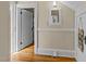 A hallway with original hardwood floors, freshly painted walls, and vintage trim at 417 Elm St, Raleigh, NC 27604
