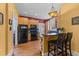 Kitchen featuring maple cabinets, black appliances, and a breakfast bar with stools at 417 Elm St, Raleigh, NC 27604