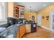 Kitchen with granite countertops, stainless steel sink, and dark tile backsplash at 417 Elm St, Raleigh, NC 27604