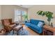 Cozy living room with a blue sofa, leather armchair, hardwood floors, and natural light at 417 Elm St, Raleigh, NC 27604