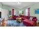 A living room featuring a red sectional sofa, hardwood floors, and vintage details at 417 Elm St, Raleigh, NC 27604