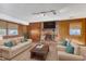 Cozy living room with wood paneled walls, fireplace, and plenty of seating at 503 Marshall Way, Durham, NC 27705