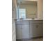 Bathroom with gray cabinets, dual sinks and a large mirror at 1113 Mountain Crown St, Durham, NC 27703