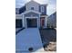 Two-story townhouse with gray siding, red front door, and an attached single-car garage in a new community at 1113 Mountain Crown St, Durham, NC 27703