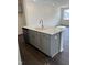 Kitchen island with stainless steel dishwasher, sink, quartz countertops, and dark hardwood flooring at 1113 Mountain Crown St, Durham, NC 27703