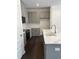 Charming kitchen boasts gray cabinetry, stainless steel appliances, quartz countertops, and hardwood floors at 1113 Mountain Crown St, Durham, NC 27703