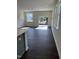 Bright living room featuring hardwood floors, large windows, and a sliding glass door to the outdoors at 1113 Mountain Crown St, Durham, NC 27703