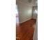 Inviting hallway with warm-toned hardwood floors and neutral walls, leading to other rooms in the home at 1404 N Main St, Roxboro, NC 27573