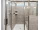 Modern bathroom shower with a glass door and gray tiled walls at 155 Shelby Meadow Ln, Angier, NC 27501