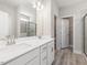 Bright bathroom featuring a double sink vanity, a large mirror and a glass enclosed shower at 155 Shelby Meadow Ln, Angier, NC 27501