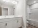 Bathroom featuring a double vanity, large mirror, and shower/tub combination at 155 Shelby Meadow Ln, Angier, NC 27501